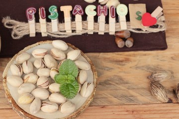 Pistachios is delicious for healthy on wood background.