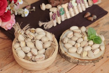 Pistachios is delicious for healthy on wood background.