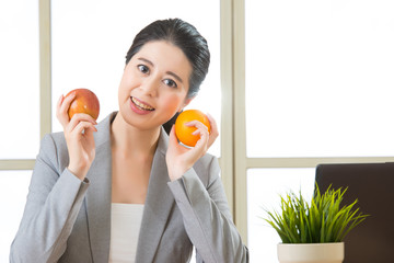 Young asian businesswoman eating healthy snack
