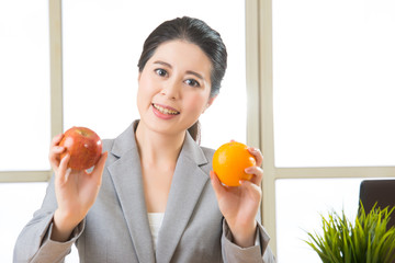 Young asian businesswoman eating healthy snack