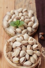 Pistachios is delicious for healthy on wood background.