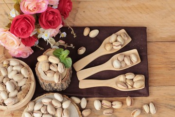 Pistachios is delicious for healthy on wood background.