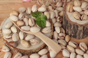 Pistachios is delicious for healthy on wood background.