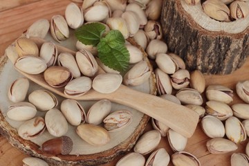 Pistachios is delicious for healthy on wood background.