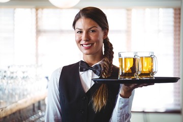 Waitress holding beers