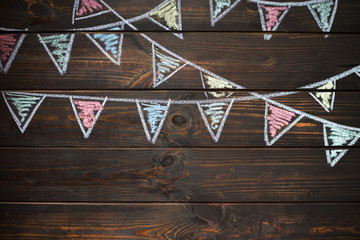 Wooden board background with drawing bunting flags.