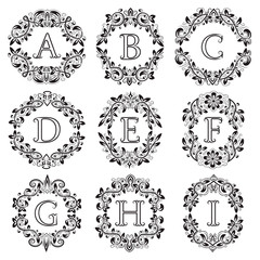 Set of isolated monograms in floral wreath. The letters are surrounded by ornamental elements.