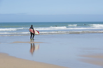Fototapeta na wymiar Surfer on Fistral Beach, Newquay, England