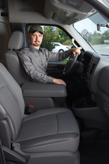 Young delivery man in a car.