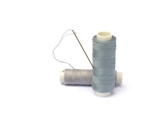 Needle, thimble, scissors, thread isolated on white background