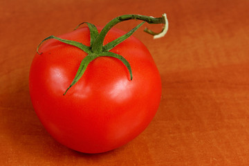 Ripe tomato on a wooden table