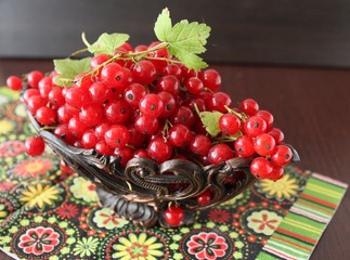 Berries red currants on a wooden background