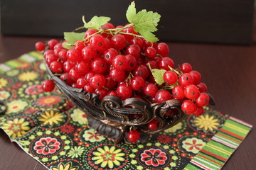 Berries red currants on a wooden background