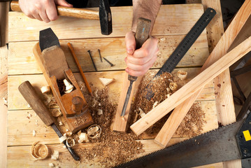 Carpenter tools on wood table background. Top view. Copy space