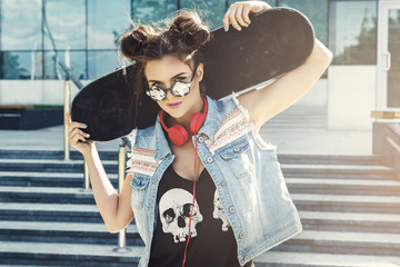 Stylish girl with a skateboard