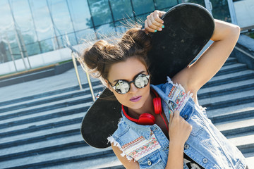 Stylish girl with a skateboard