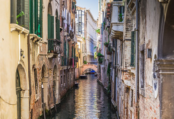 Obraz na płótnie Canvas Narrow canal among old colorful brick houses in Venice, Italy.