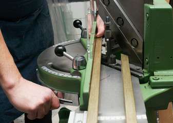 Craftsman working on frame in frameshop.