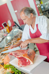 Man cutting raw meat