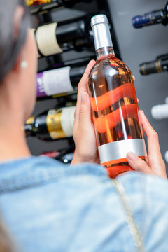 Woman choosing a bottle of wine