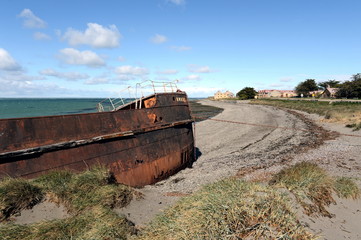 Rusty ship on the shore of the Strait of Magellan in the village of San Gregorio.