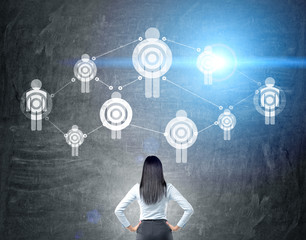 Businesswoman looking at targeting sketch