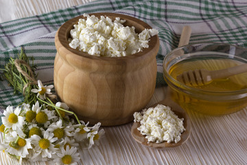 Honey, cottage cheese and chamomile flowers