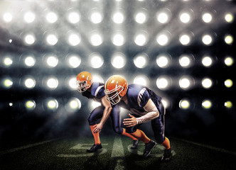 Football players in a blue uniform on green grass