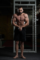Obraz na płótnie Canvas Handsome Body Builder Making Most Muscular Pose