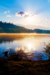 Beautiful lake with mountains in the background at sunrise.