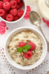 Porridge with addition of fresh raspberries, roasted sunflower and chia seeds, healthy and delicious breakfast, top view