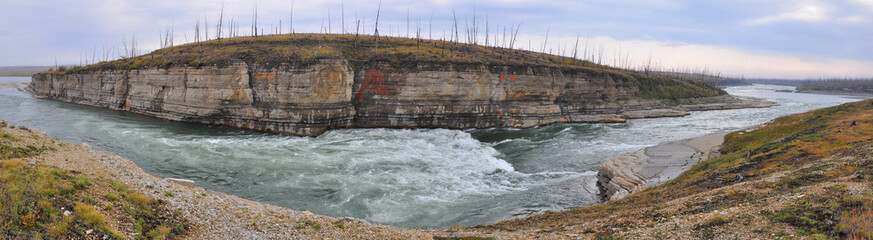 Panorama of rapid in a rocky canyon.