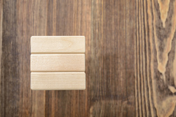Tower of wooden blocks placed on a table.