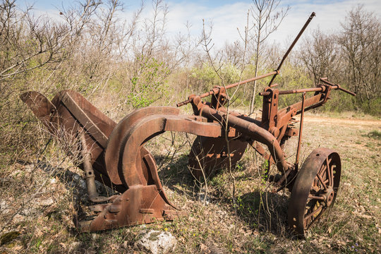 Old rusty iron plow abandoned.