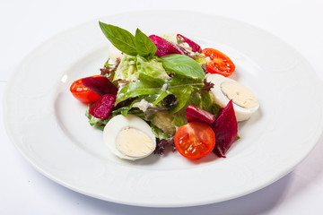 Salad with eggs and cherry