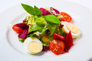 Salad with eggs and cherry