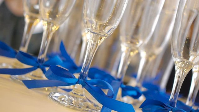 Glasses of champagne with blue ribbons, set