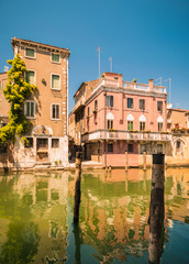 Fototapeta na wymiar Chioggia houses create colorful reflections in the water of the