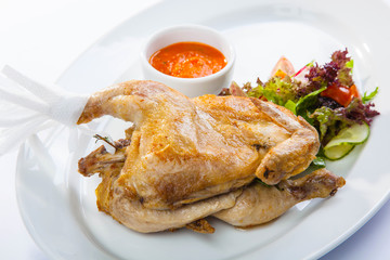 Chicken with sauce and salad