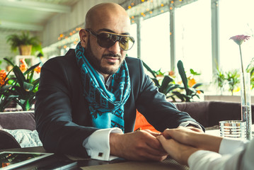 Arab man and girl holding hands in the restaurant