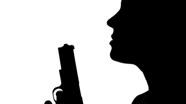 Person blowing on the barrel of a gun. Silhouette. White