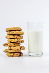 Glass of milk and cookies isolated on white