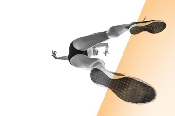 Composite image of low angle female athlete jumping