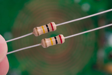 Closeup 200K or 200,000 Ohms resistors against electronic board.
