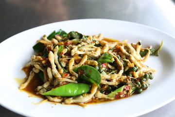 Spicy puff razor clams in the dish on white background.