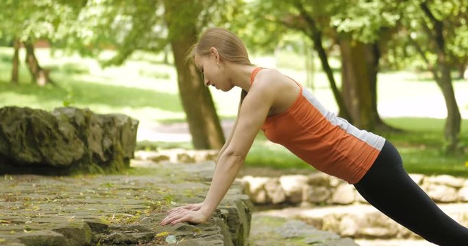 attractive young girl exercise in the park