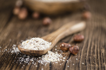 Hazelnuts (grounded) on wooden background