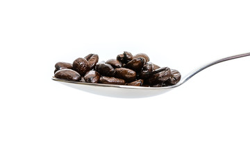 spoon with coffee beans. isolated white background.