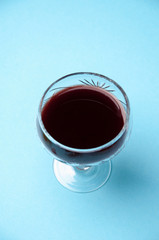 Red wine in a glass isolated on blue background