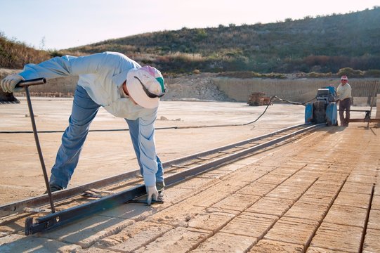 Tufa stone quarry: worker setting the track for the vertical sawing machine